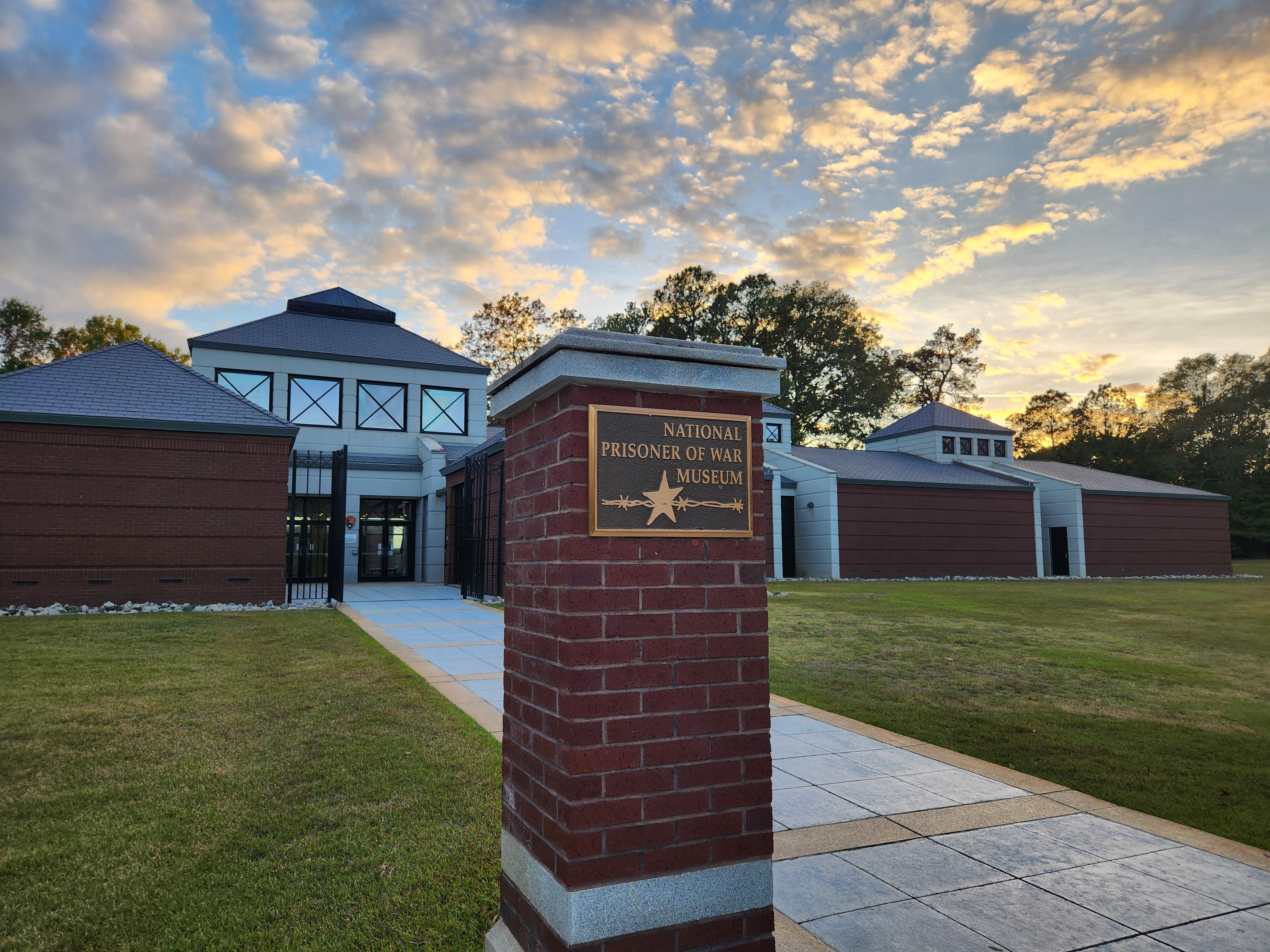 Large brick museum with a sign in front reading "The National Prisoner of War Museum"