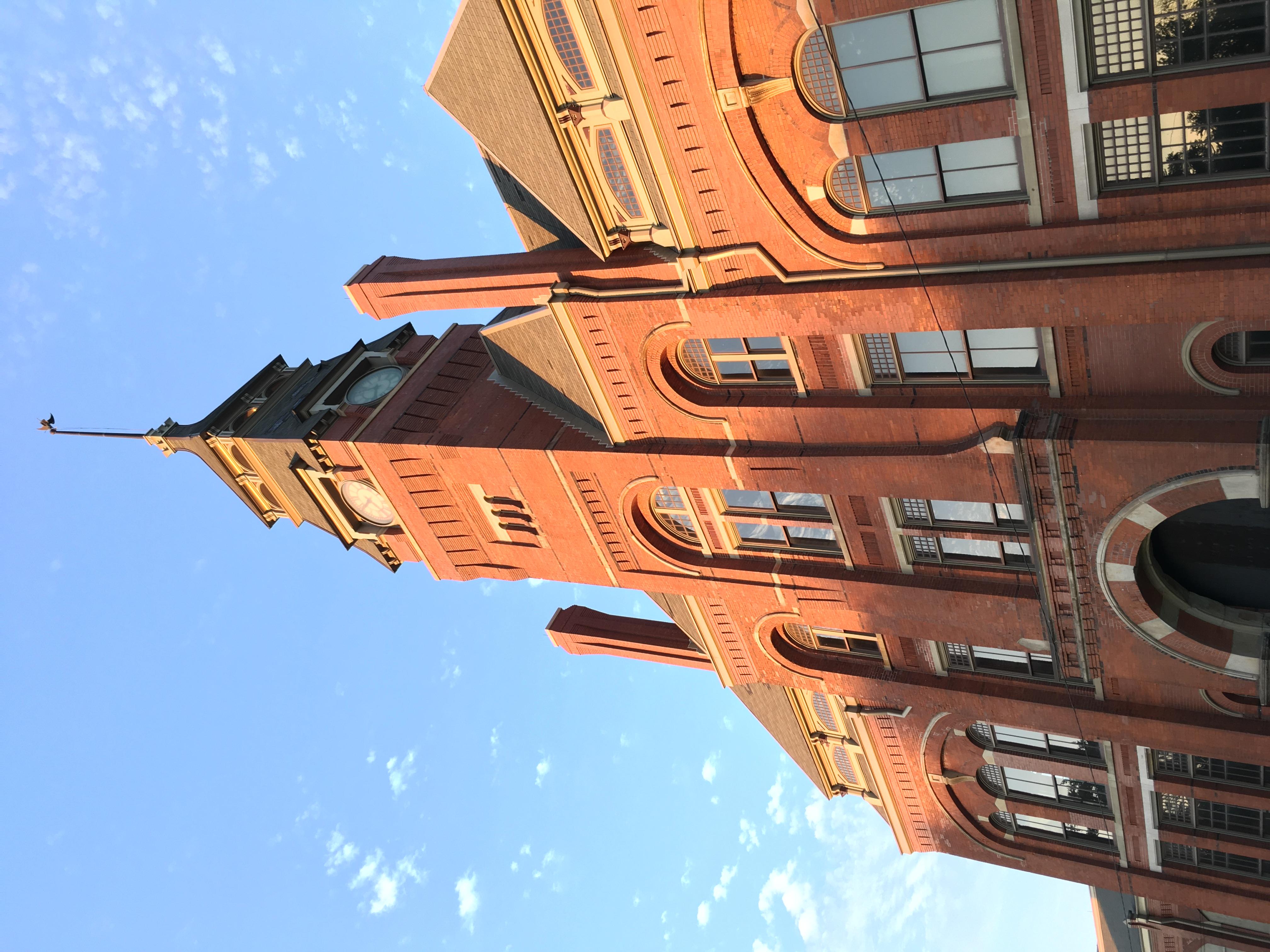 front of clocktower taken looking up with blue sky, sunny